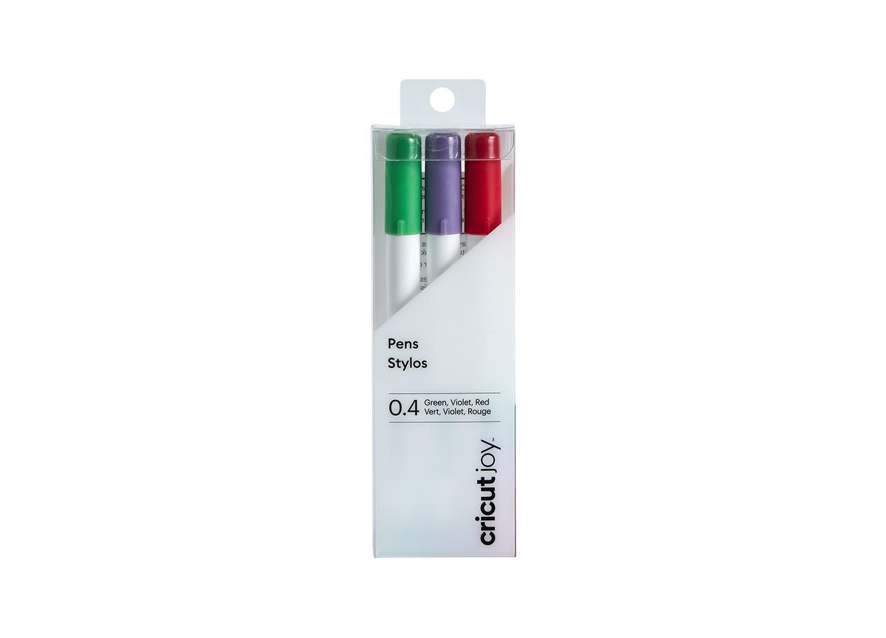Packung mit drei Stiften: grün, violett, rot. Die Verpackung ist aus klarem Kunststoff und die Stifte tragen das Cricut Joy Logo.