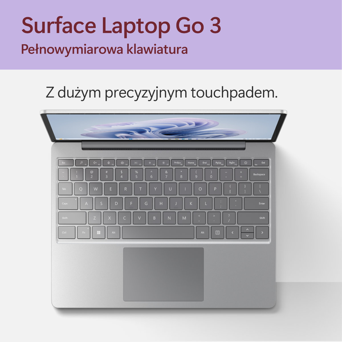 Srebrna klawiatura laptopa z panelem dotykowym. Tekst na górze: 'Surface Laptop Go 3'.