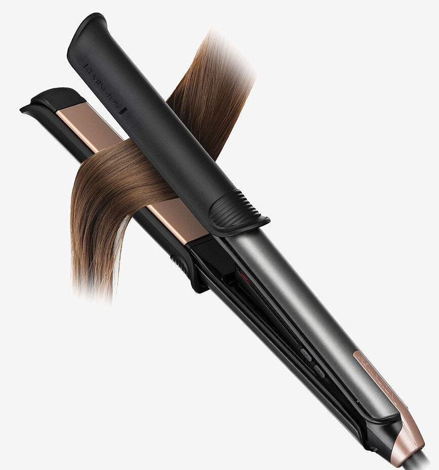 Czarna i różowo-złota prostownica Remington z pasmami włosów przechodzącymi przez nią.