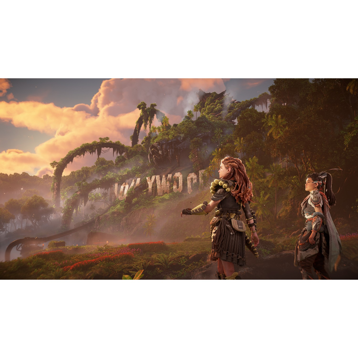 Two women in a jungle. The Hollywood sign is visible in the background.