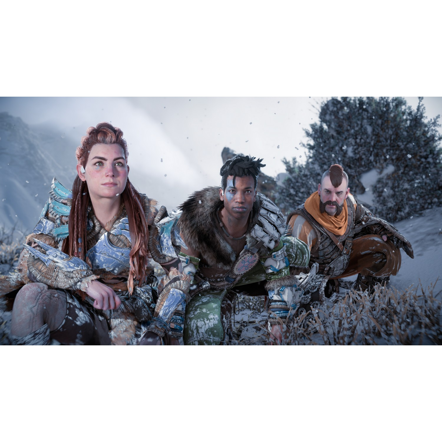 Three people in a snowy landscape. They are crouched down, wearing winter clothing and looking at the camera.
