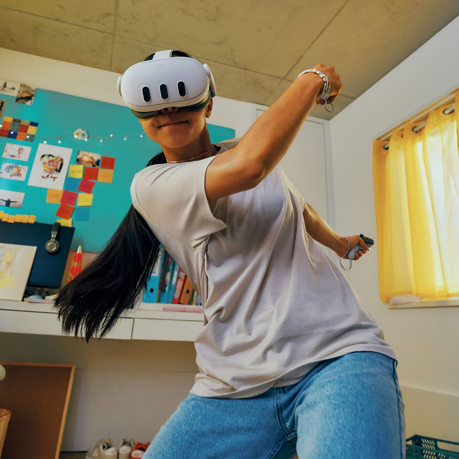 Person wearing VR headset, holding controllers, in a room with colorful decor.