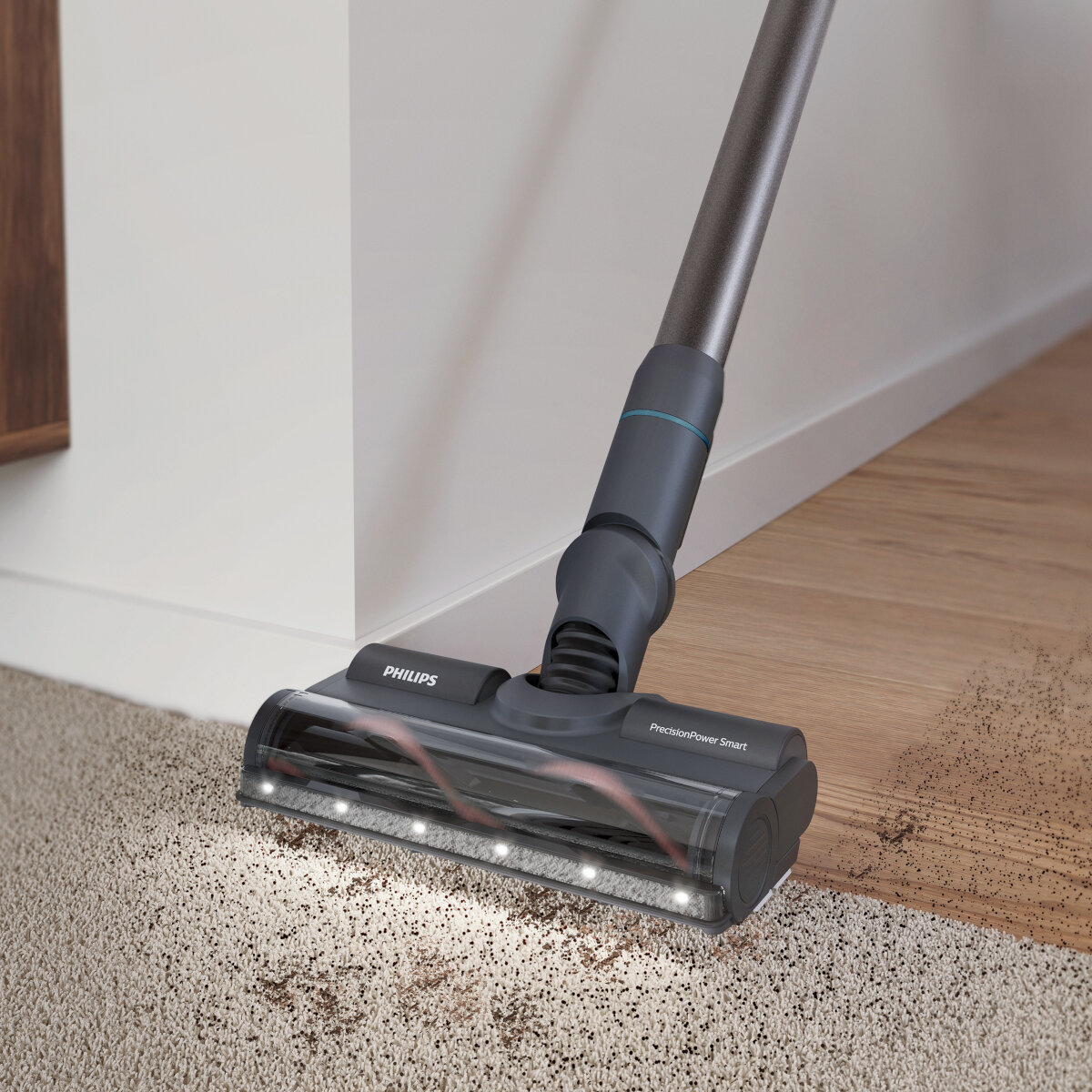 Głowica odkurzacza na dywanie z brudem. Odkurzacz ma światła i logo Philips.