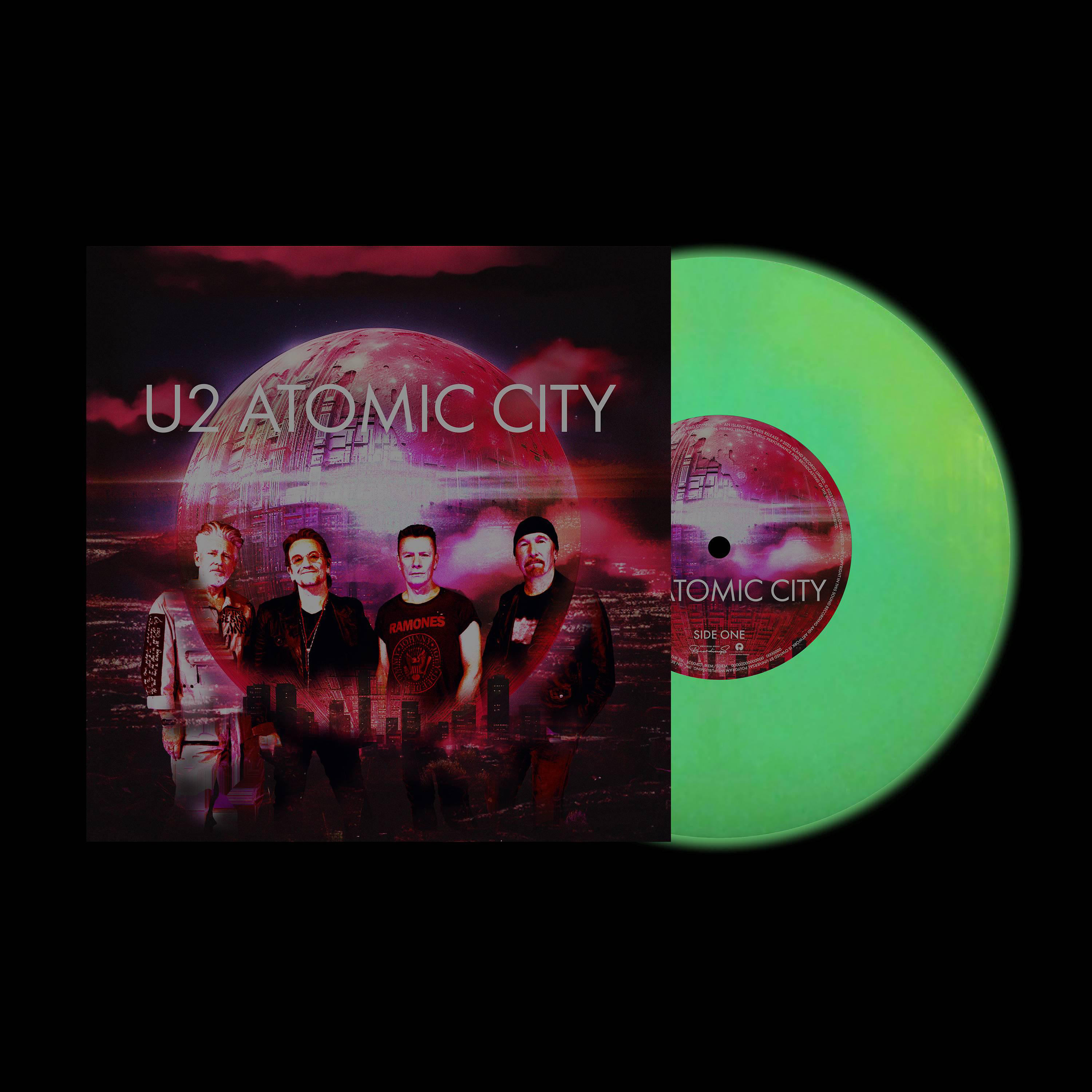 U2 "Atomic City" Albumcover, mit Bandbild und neongrüner Vinyl-Schallplatte.