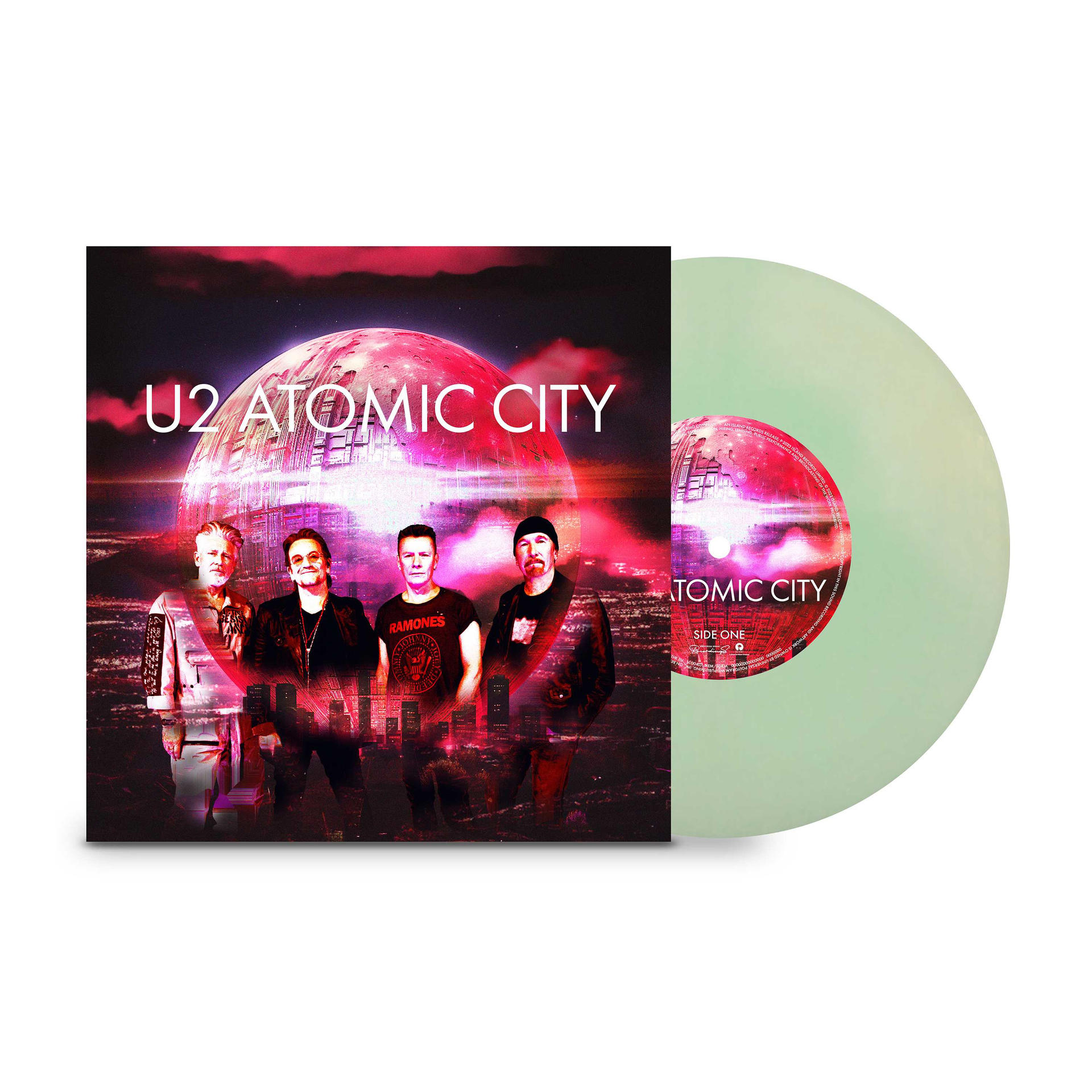 U2s 'Atomic City' Albumcover und eine grüne Vinylplatte. Gruppe von vier auf dem Cover.
