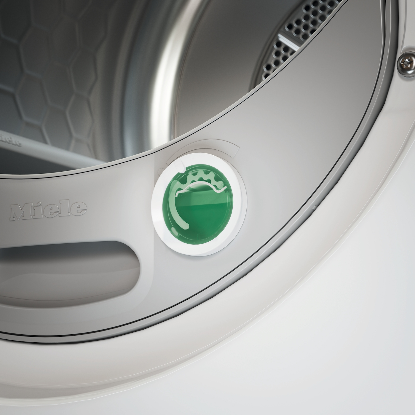 Nahaufnahme eines Miele Trockners mit einem grünen Drehknopf und dem Miele-Logo.