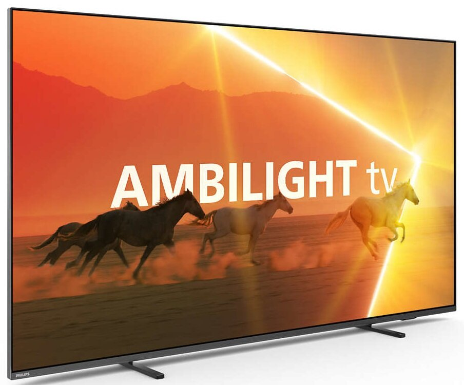 Duży telewizor wyświetla biegnące konie ze słowami 'AMBILIGHT tv' na tle zachodu słońca.
