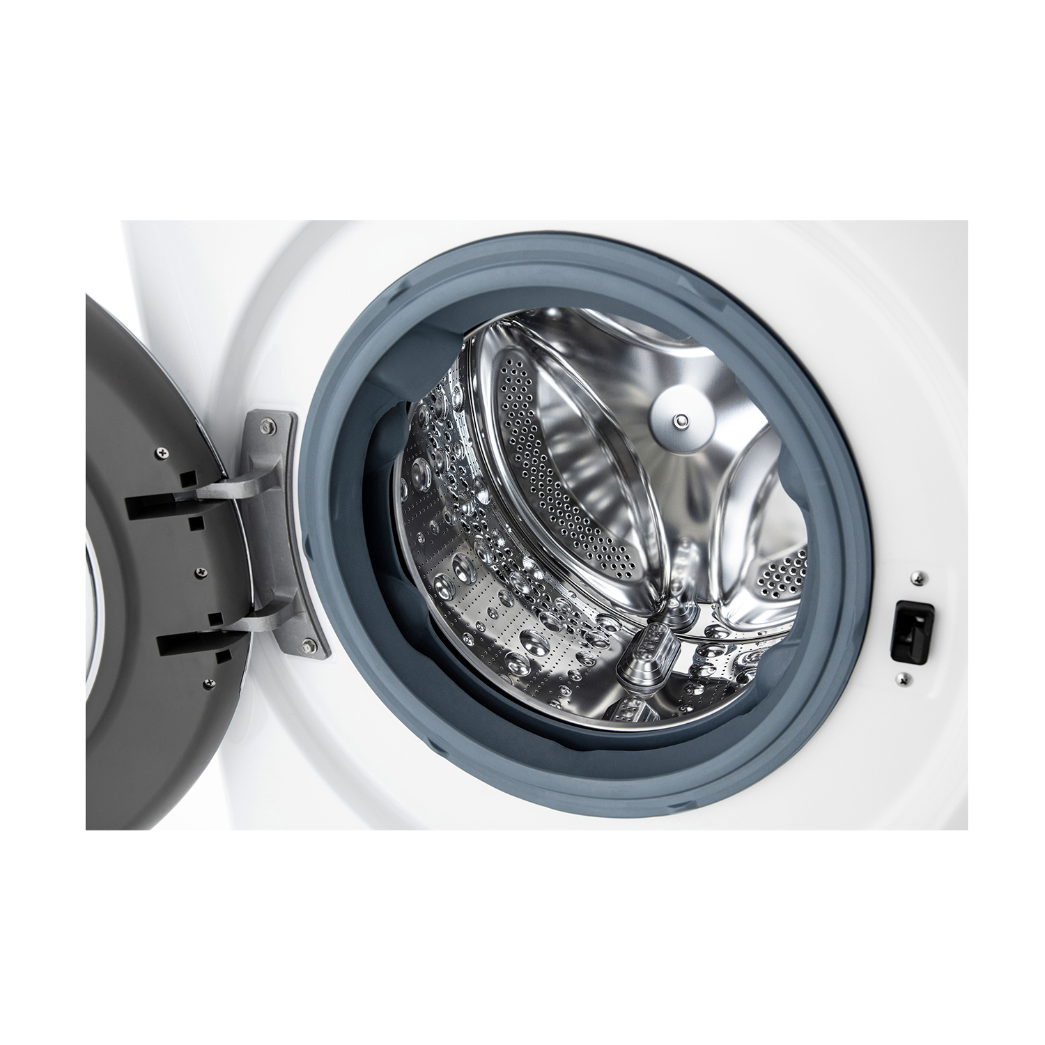 Interno lavatrice: Cestello in acciaio inox, porta aperta, guarnizione grigia visibile.