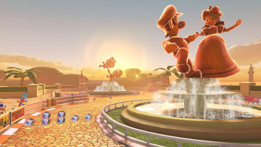 Pomniki Mario i Peach na fontannie. W tle palmy i zachód słońca.