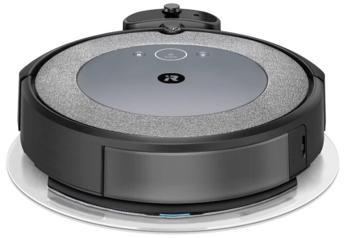 Czarny robot sprzątający Roomba na białej powierzchni.