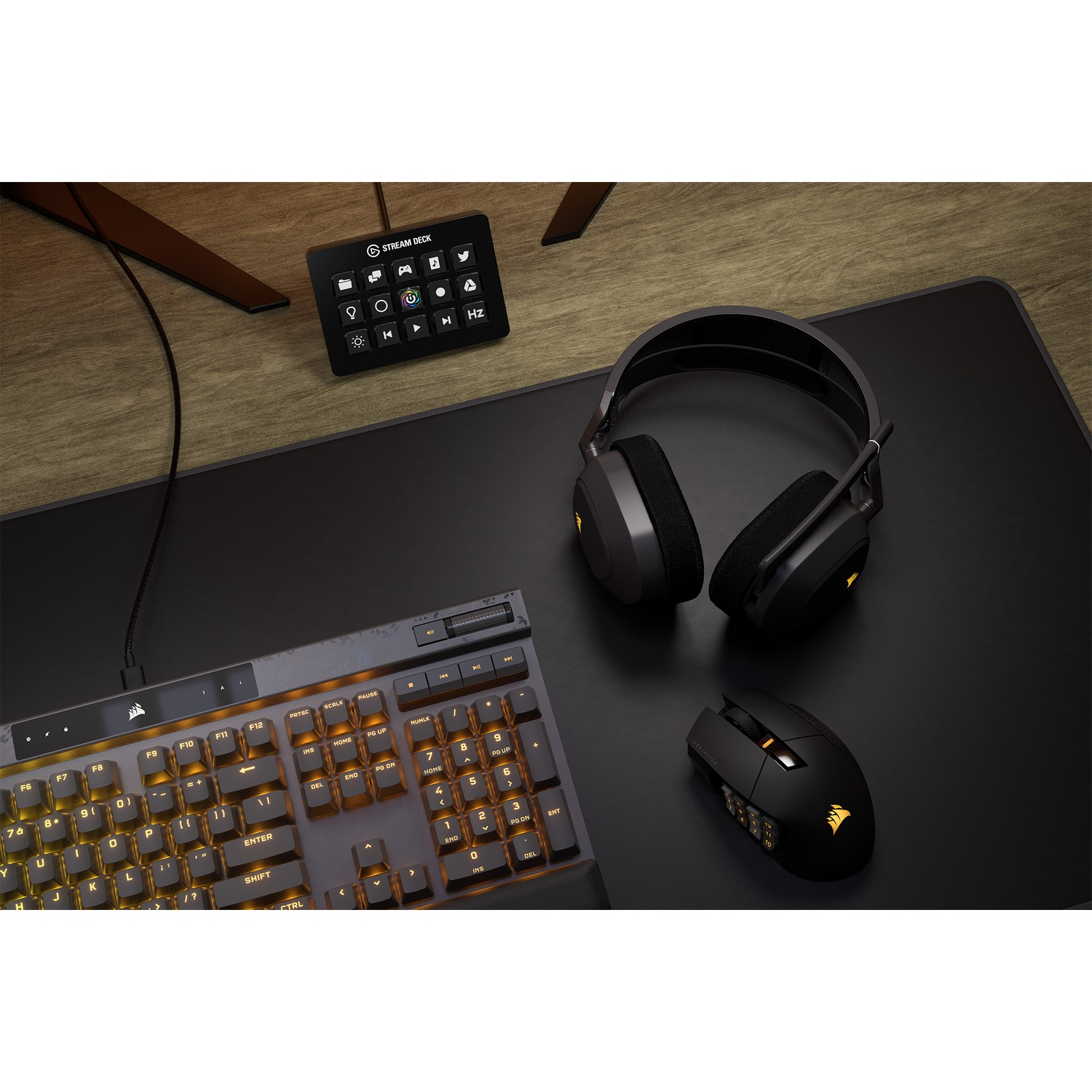 Configuration de bureau: clavier, souris, casque et Stream Deck. Tout noir sur une surface en bois.