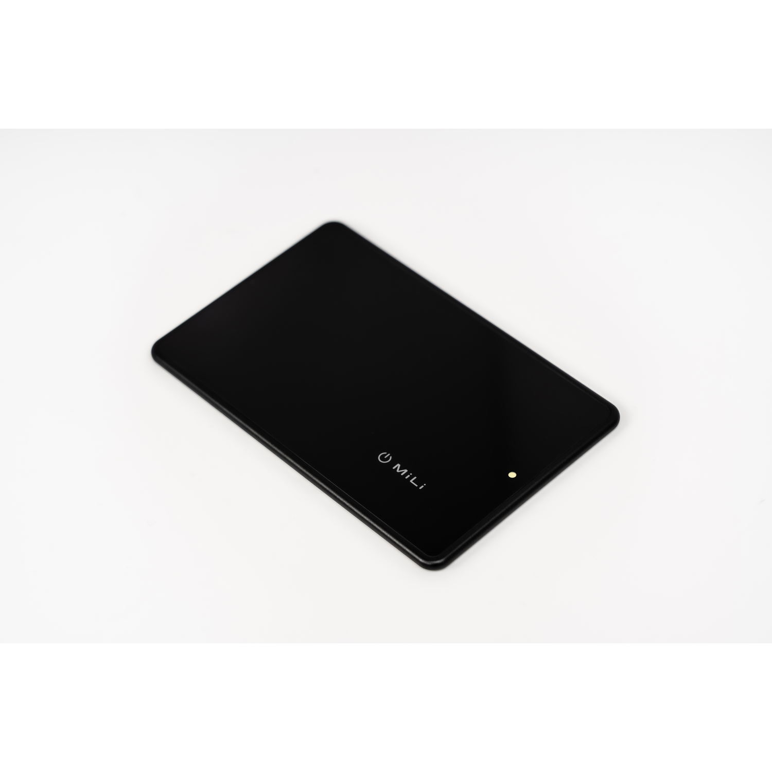 A black, rectangular, Mili device. Has a white Mili logo and a small green light. White background.