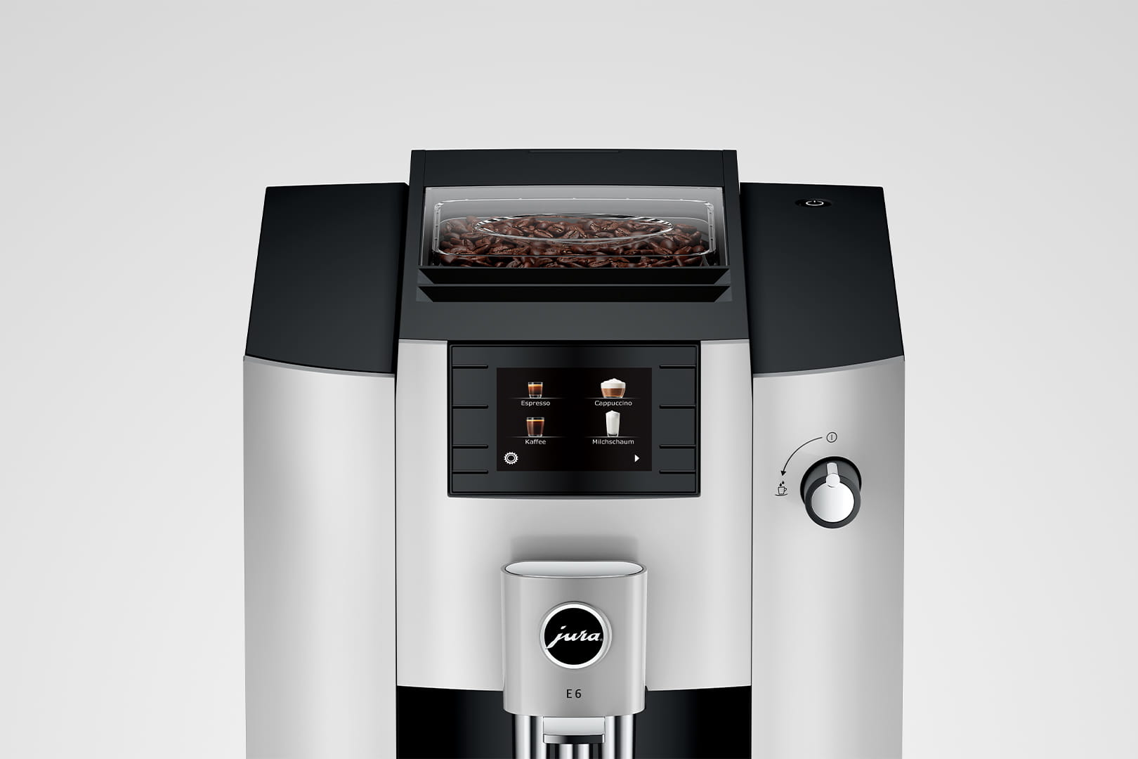 Primer plano de una cafetera Jura E6 con contenedor de granos y panel de control.