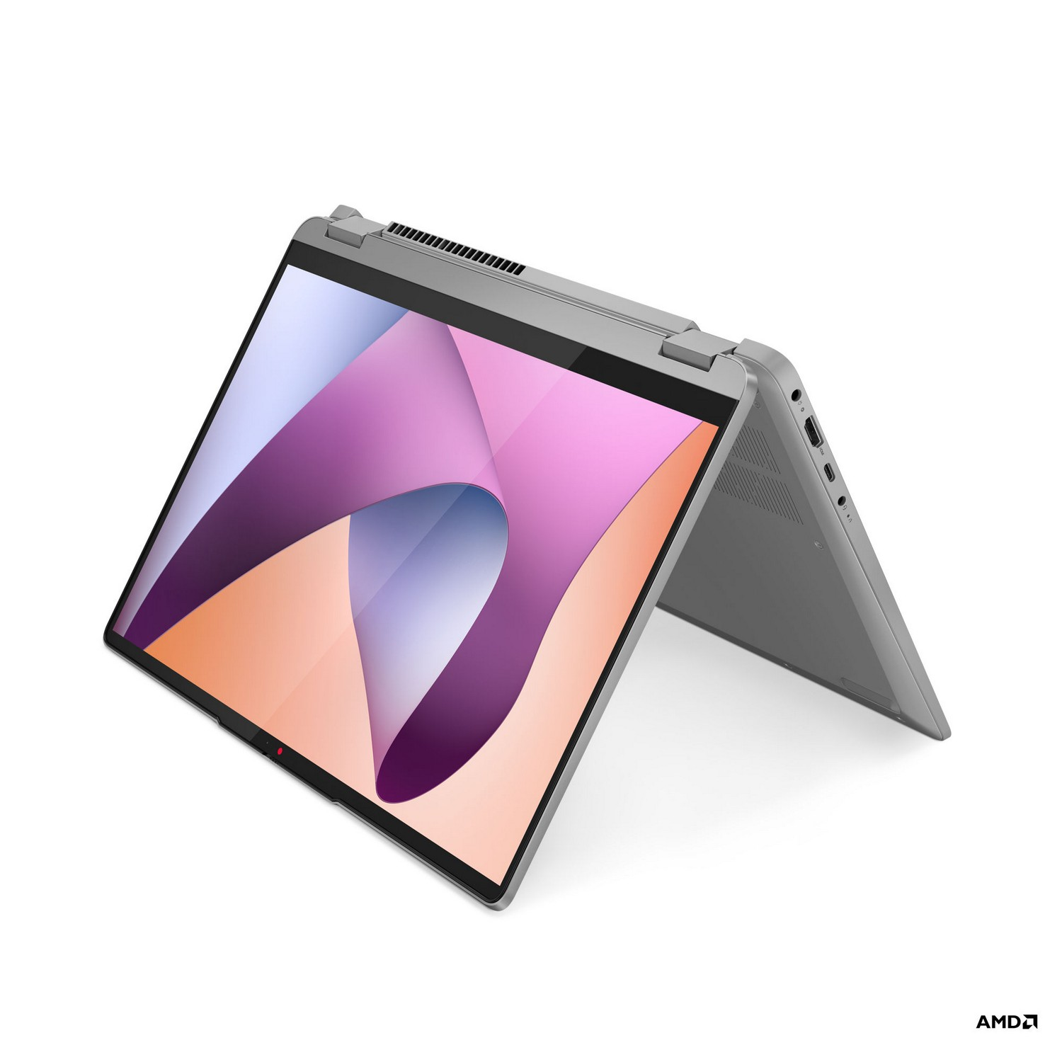 Un ordinateur portable gris avec l'écran ouvert. L'écran affiche un design abstrait rose et orange.