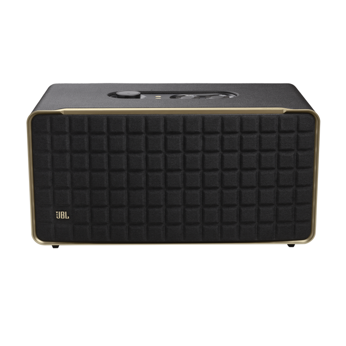 Altavoz JBL negro con borde dorado, sobre fondo negro.