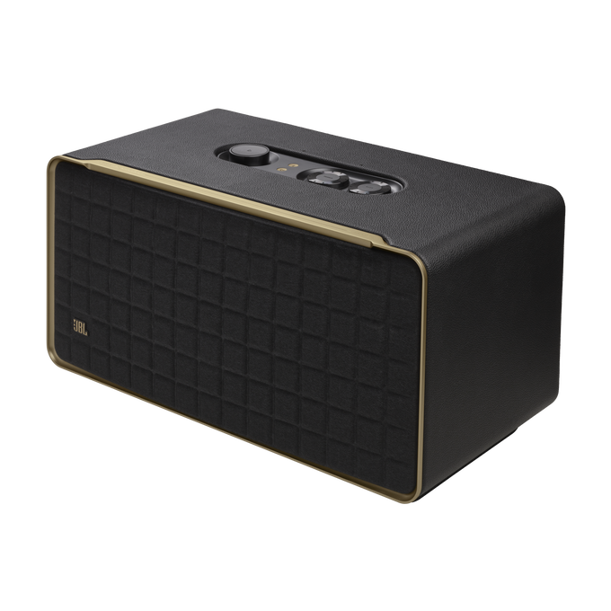 Altavoz JBL negro con ribete dorado. Es un altavoz rectangular con frontal de tela.