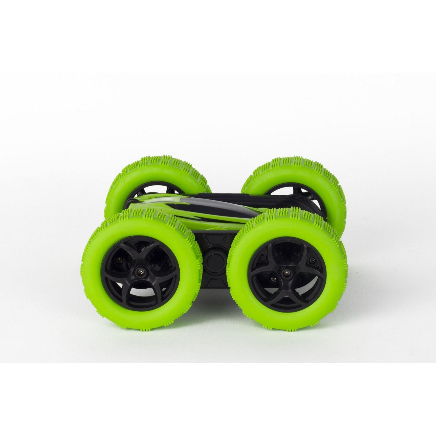 A green and black toy car with four wheels, designed to flip over on a white surface.