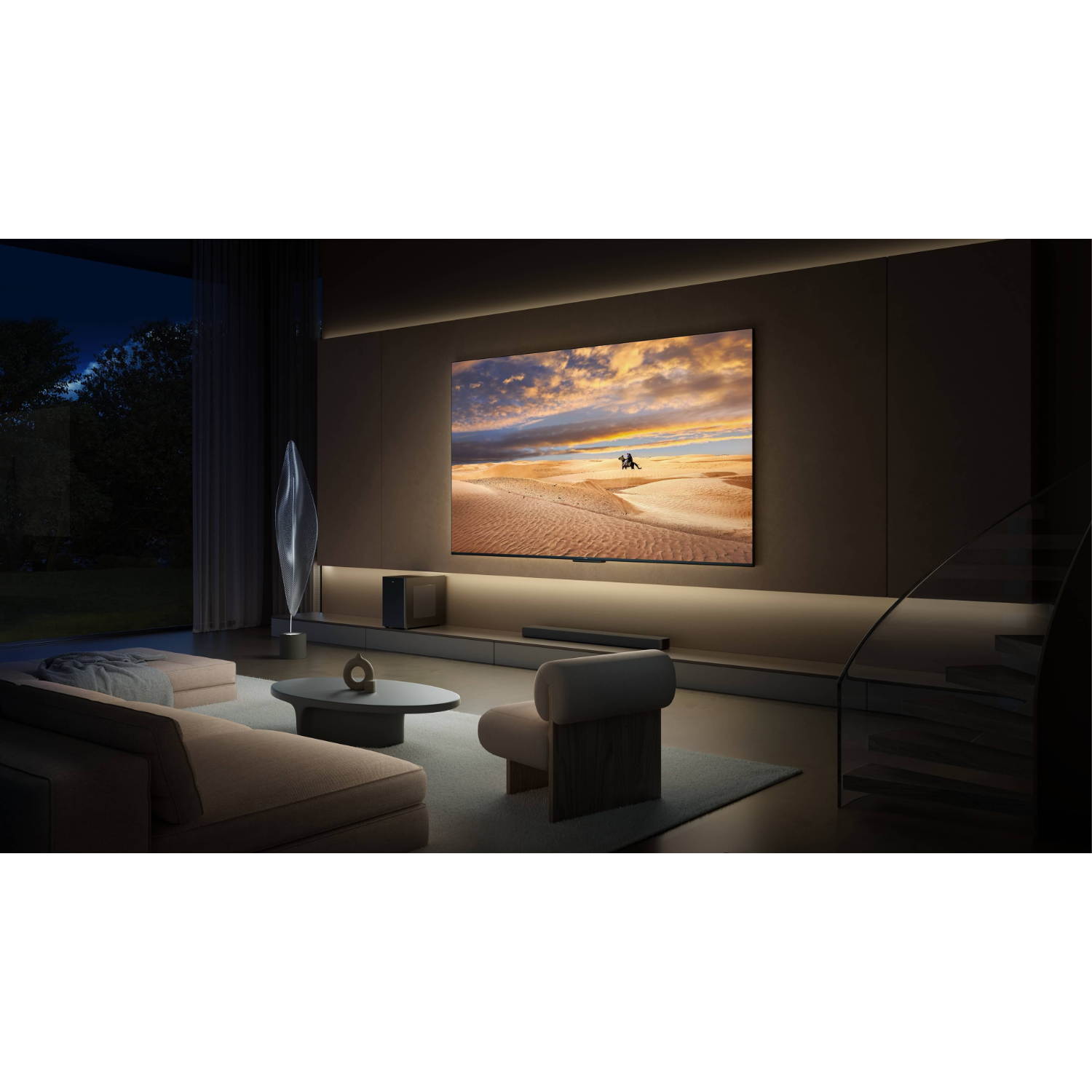 Living room with a large TV displaying a sunset scene. A sofa and chairs are in view.