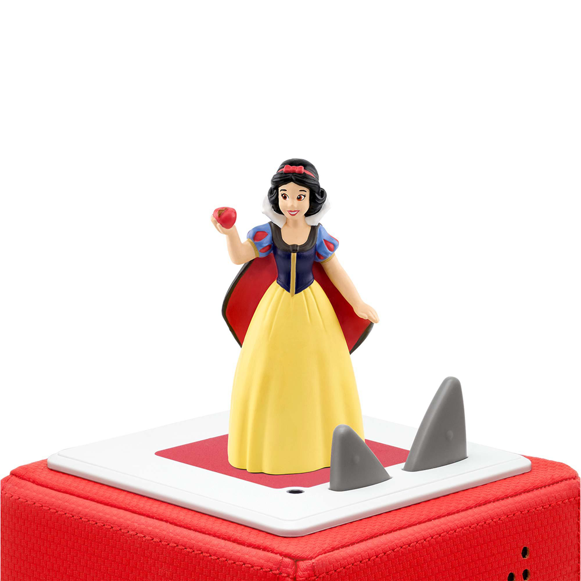 Schneewittchen-Figur mit Apfel, auf roter Basis mit grauen, haifischflossenartigen Vorsprüngen.