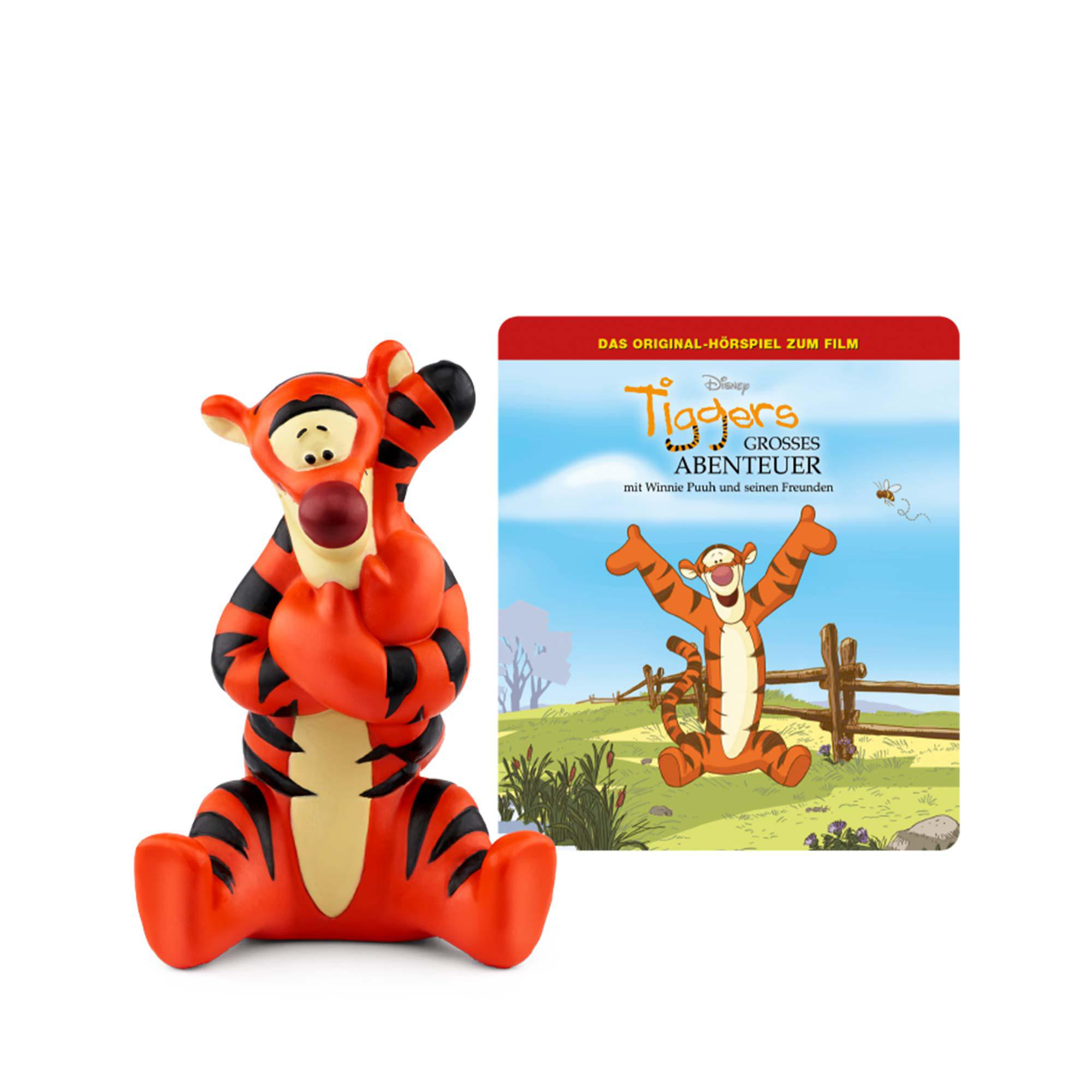 Tigger-Spielzeug und Buchcover. Tigger ist rot und schwarz. Buchcover zeigt Tigger.