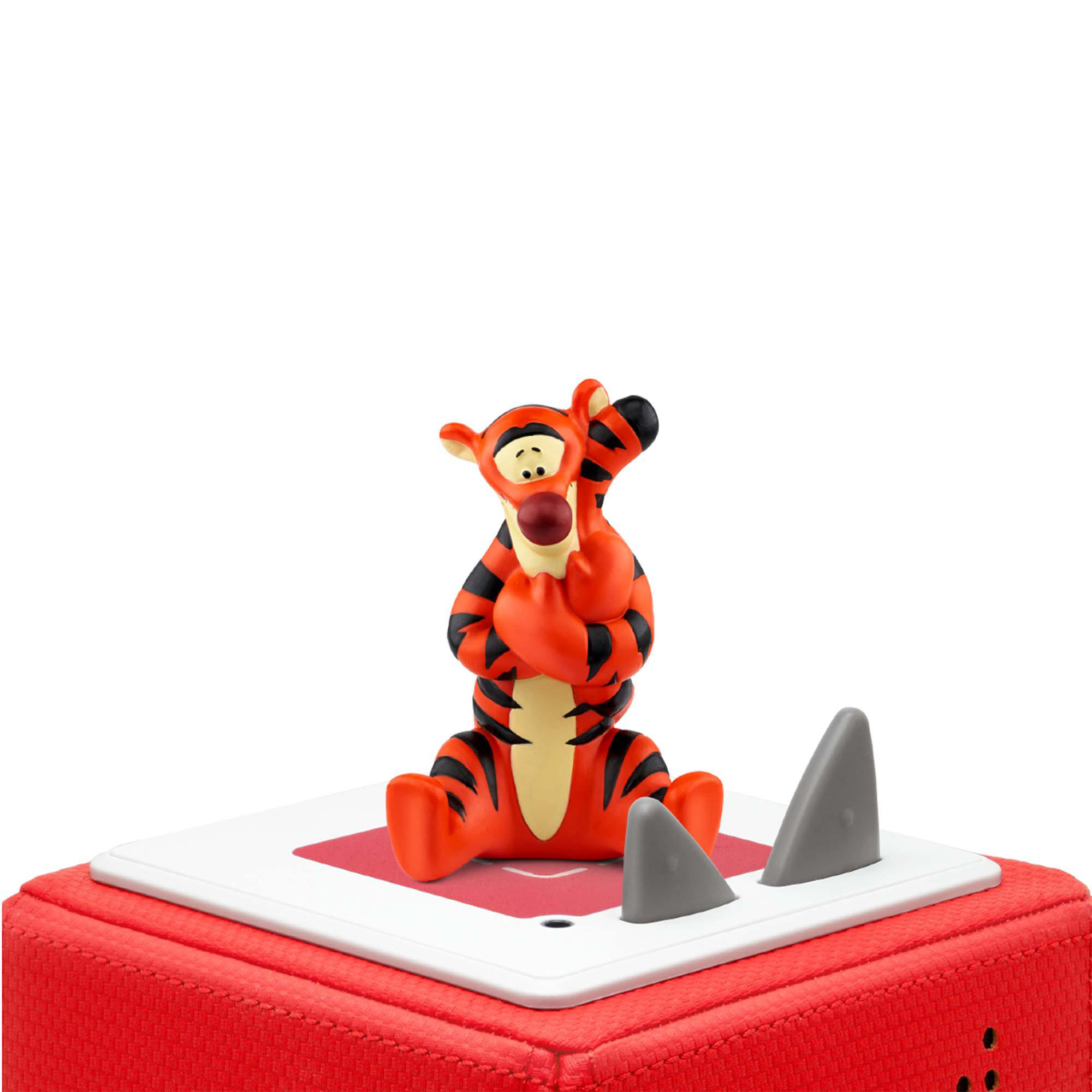 Eine Tigger-Figur sitzt auf einem roten Würfel. Er ist orange und schwarz, mit grauen Haifischflossendekorationen.