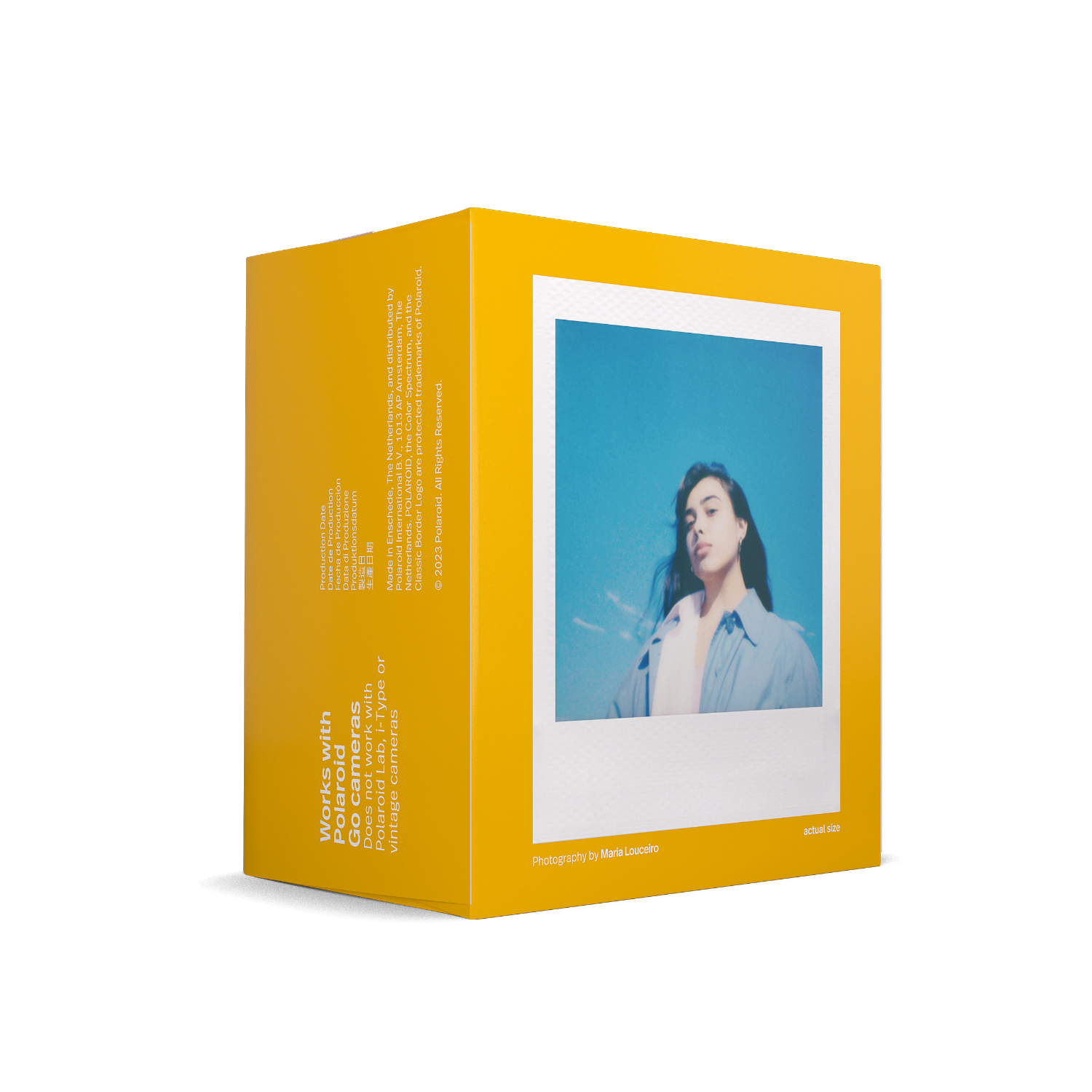 A yellow box with a Polaroid photo inside. A woman is in the photo, with a blue background.