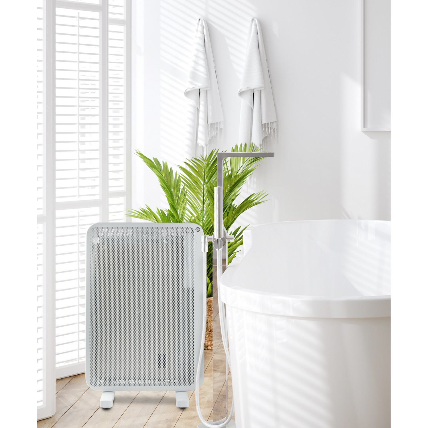 Bathroom interior with a white heater, towels, a plant, and a bathtub.