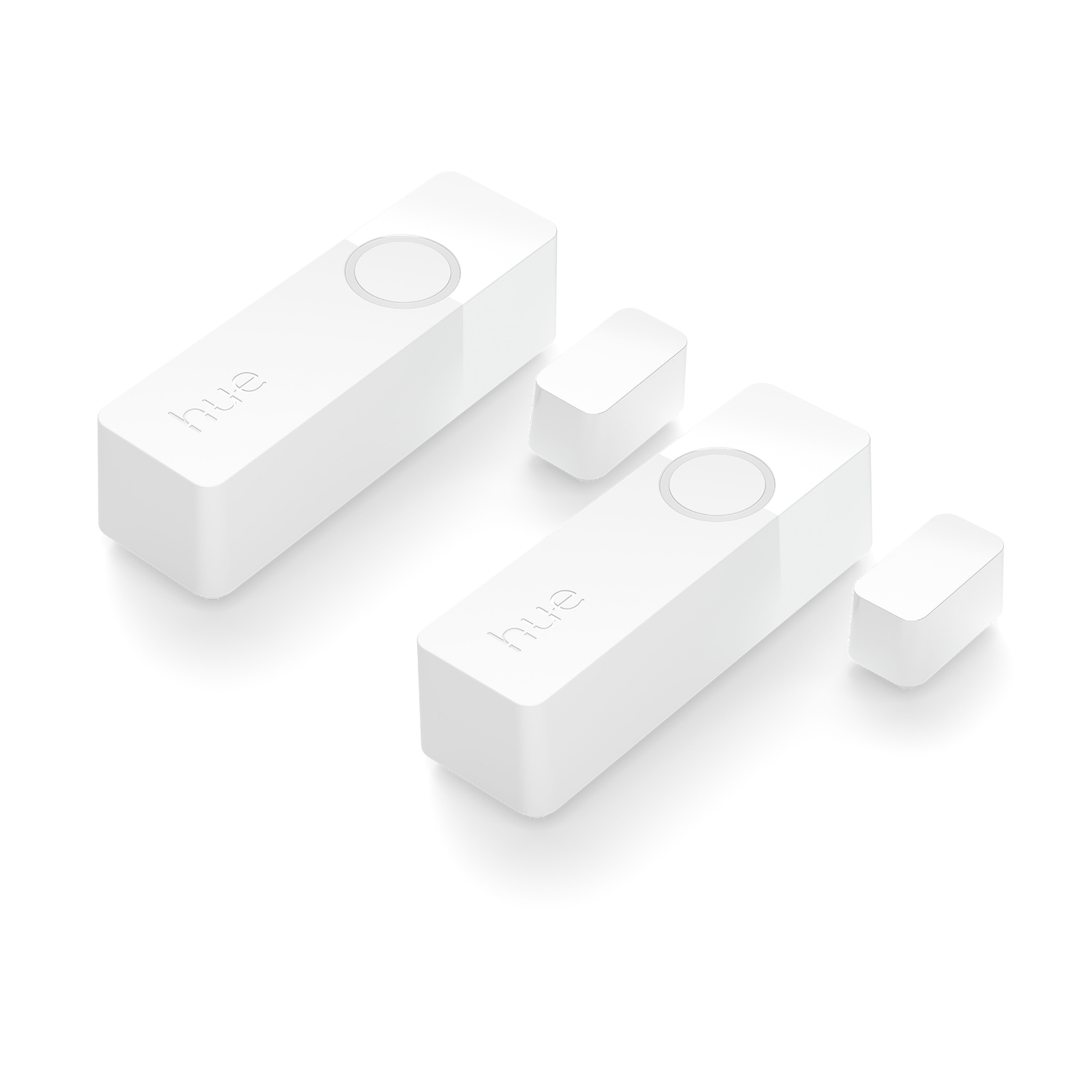 Two white rectangular Hue devices with a circular button on top. Two smaller white rectangles are also visible.