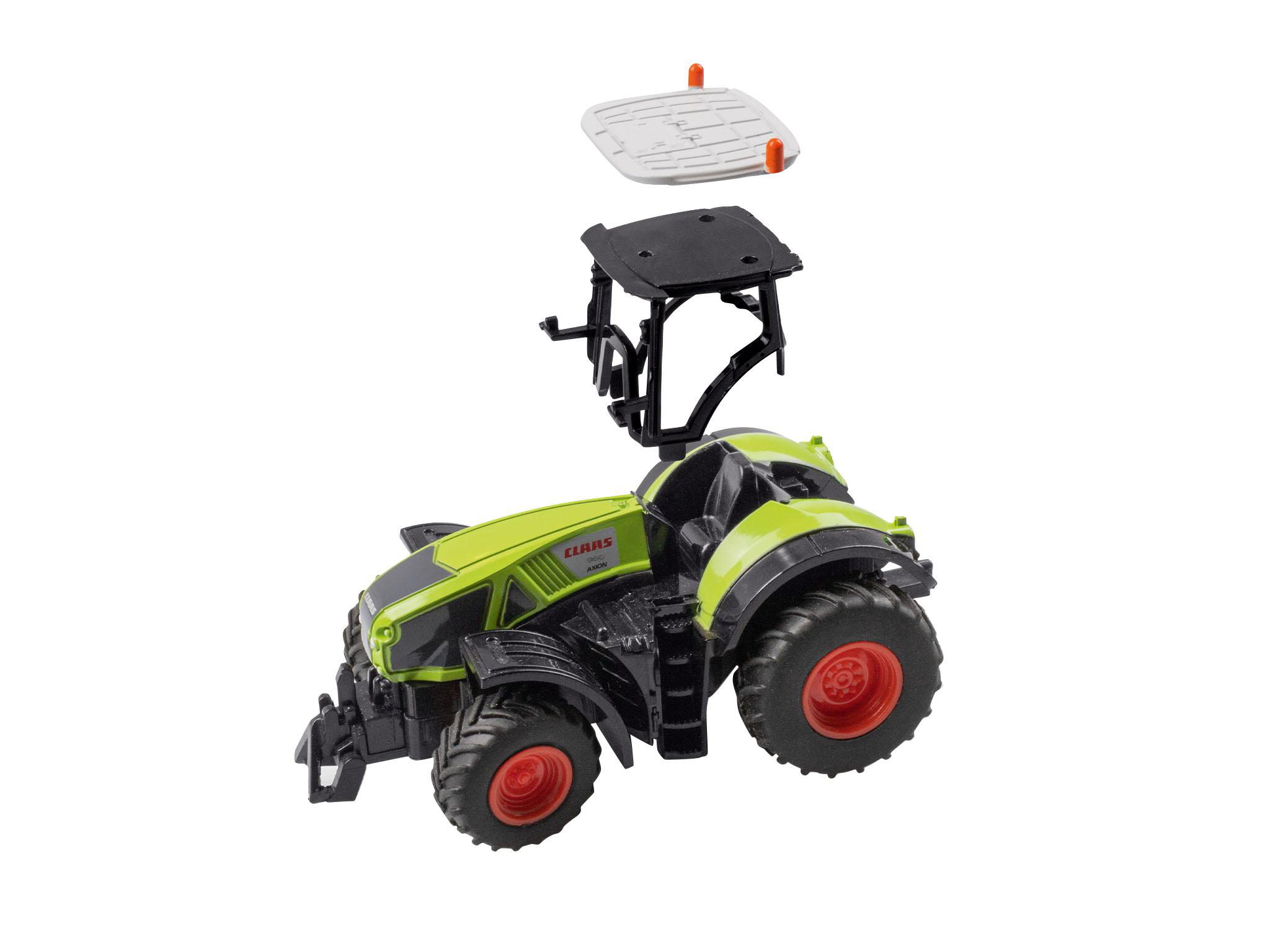 Ein grüner Spielzeugtraktor mit abnehmbaren Teilen, auf weißem Hintergrund.