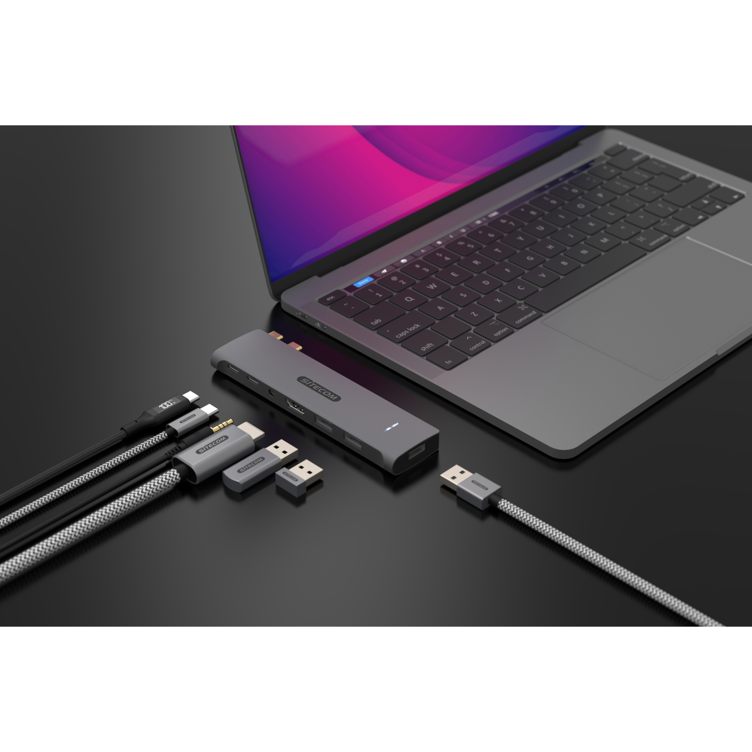 Laptop connected to a hub with cables and other devices.
