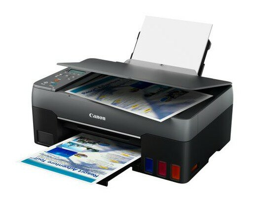 Drukarka Canon drukująca strony z kolorowymi obrazami. Otwarta taca na papier, czarno-szary design.