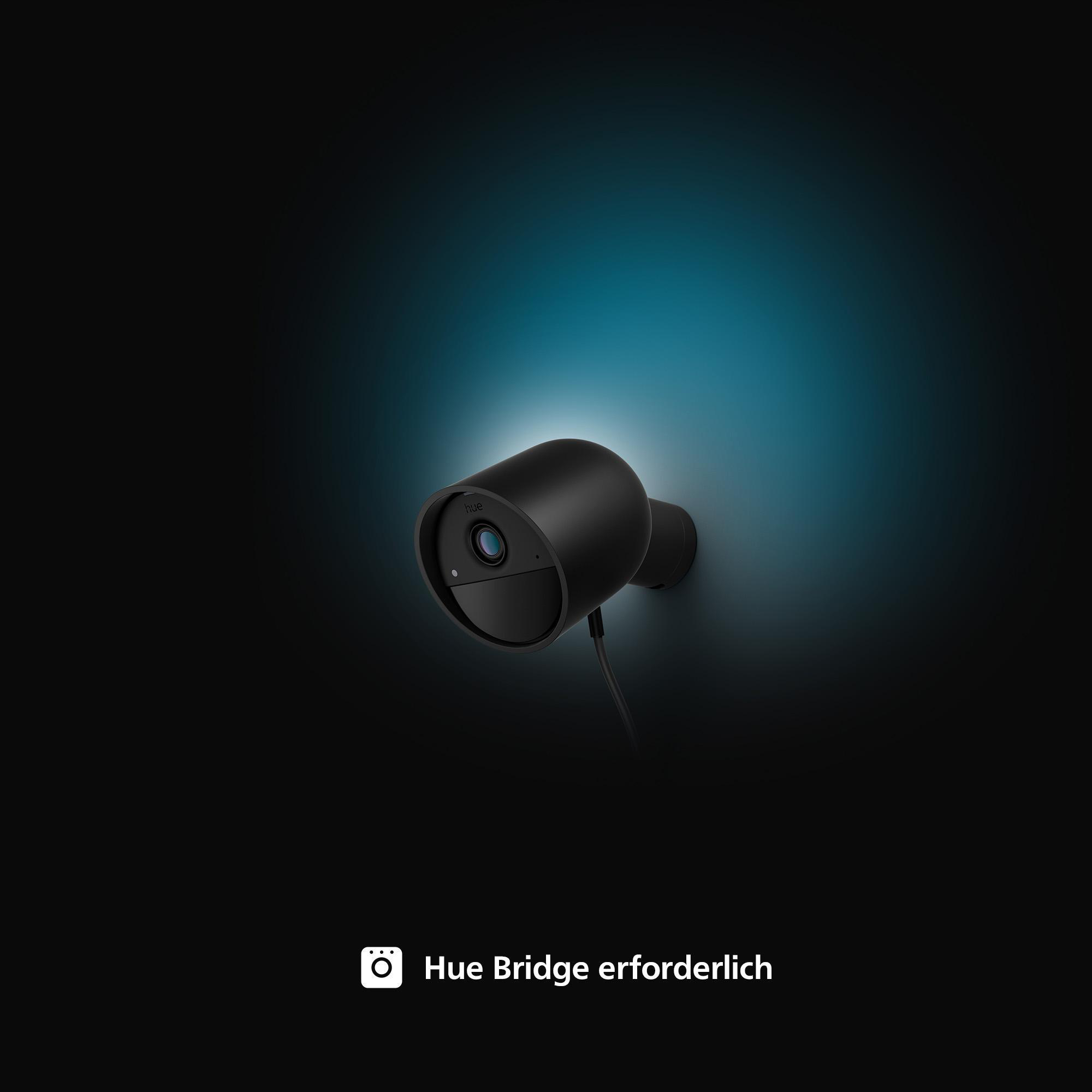 Schwarze Überwachungskamera, an der Wand montiert, mit blauem Licht und Text: Hue Bridge erforderlich.