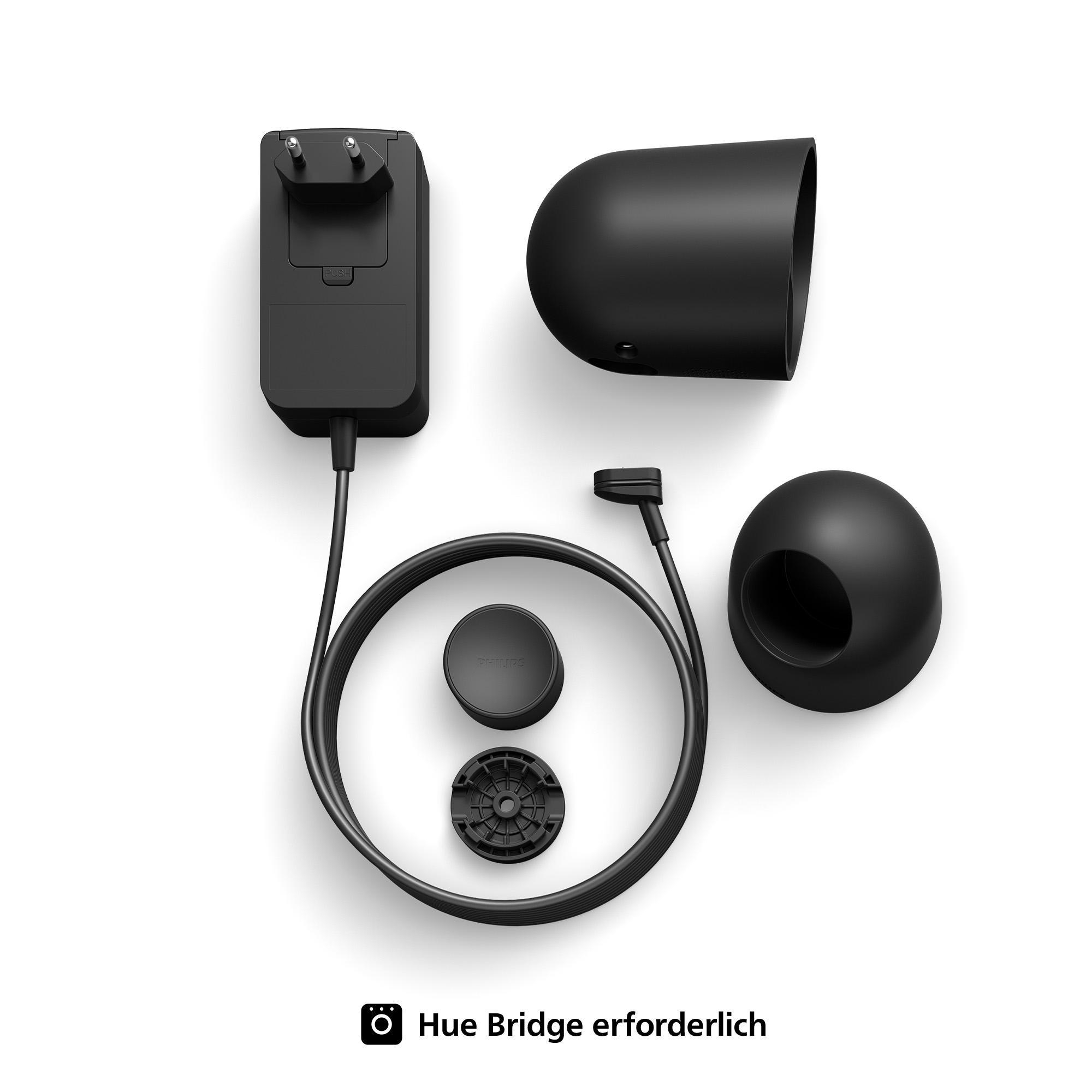 Ein schwarzes Hue Bridge Netzteil mit Stecker, Kabel und anderen Komponenten, auf weißem Untergrund.