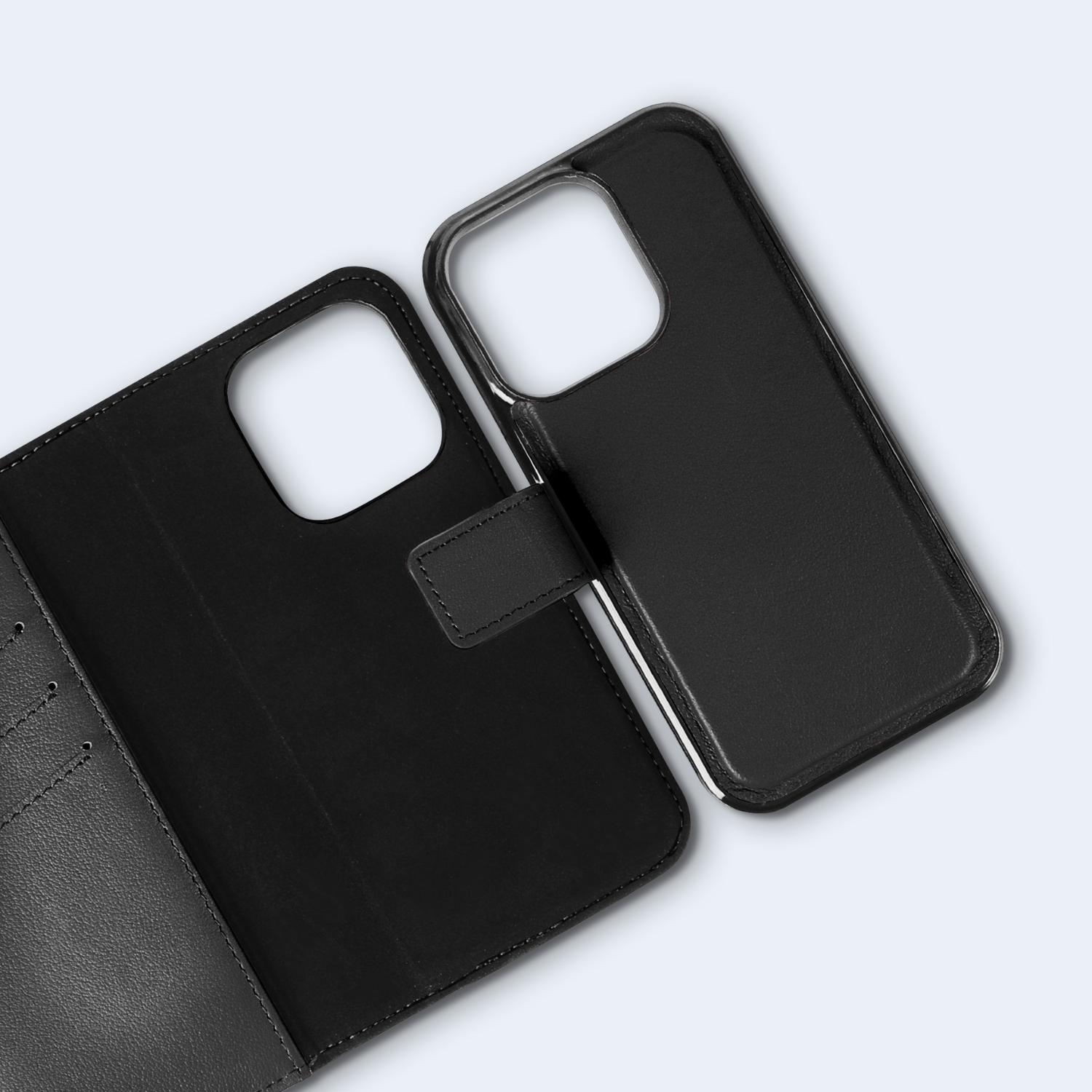 Open zwarte telefoonhoes met een zwarte telefoon erin. De hoes ligt op een lichtblauw oppervlak.