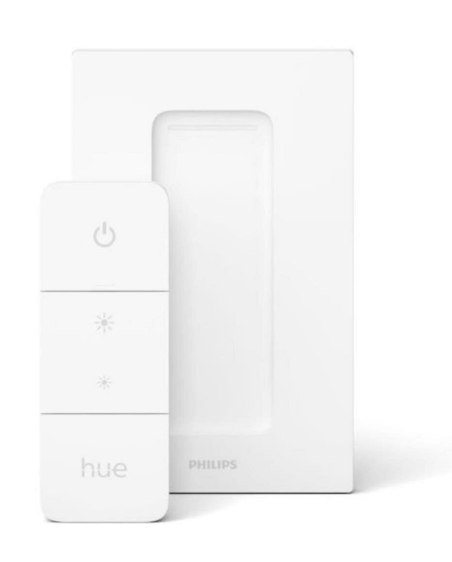 Biały pilot Philips Hue z trzema przyciskami i białym włącznikiem ściennym po prawej stronie.