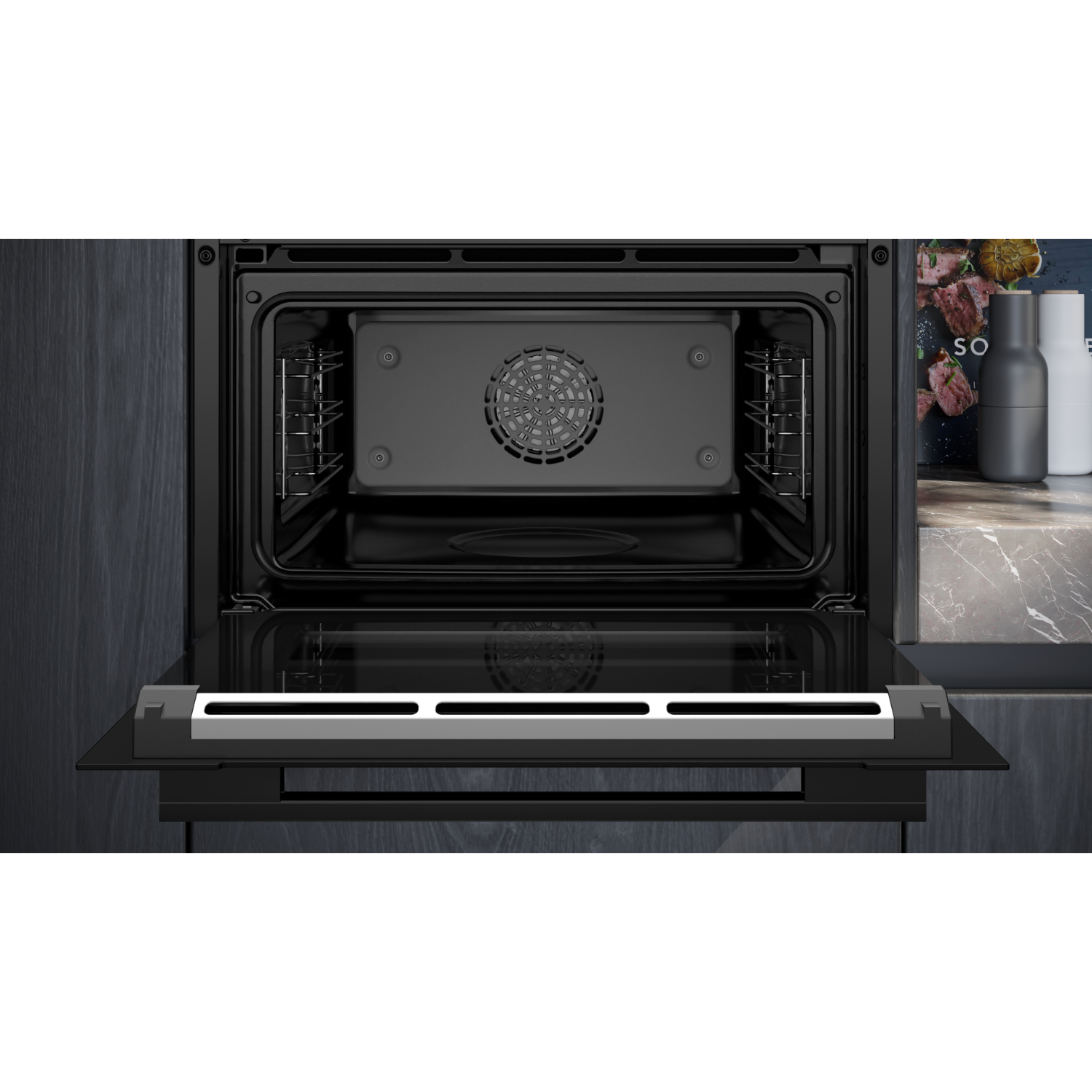 Open black oven with interior visible. Fan and racks are inside. Dark background.