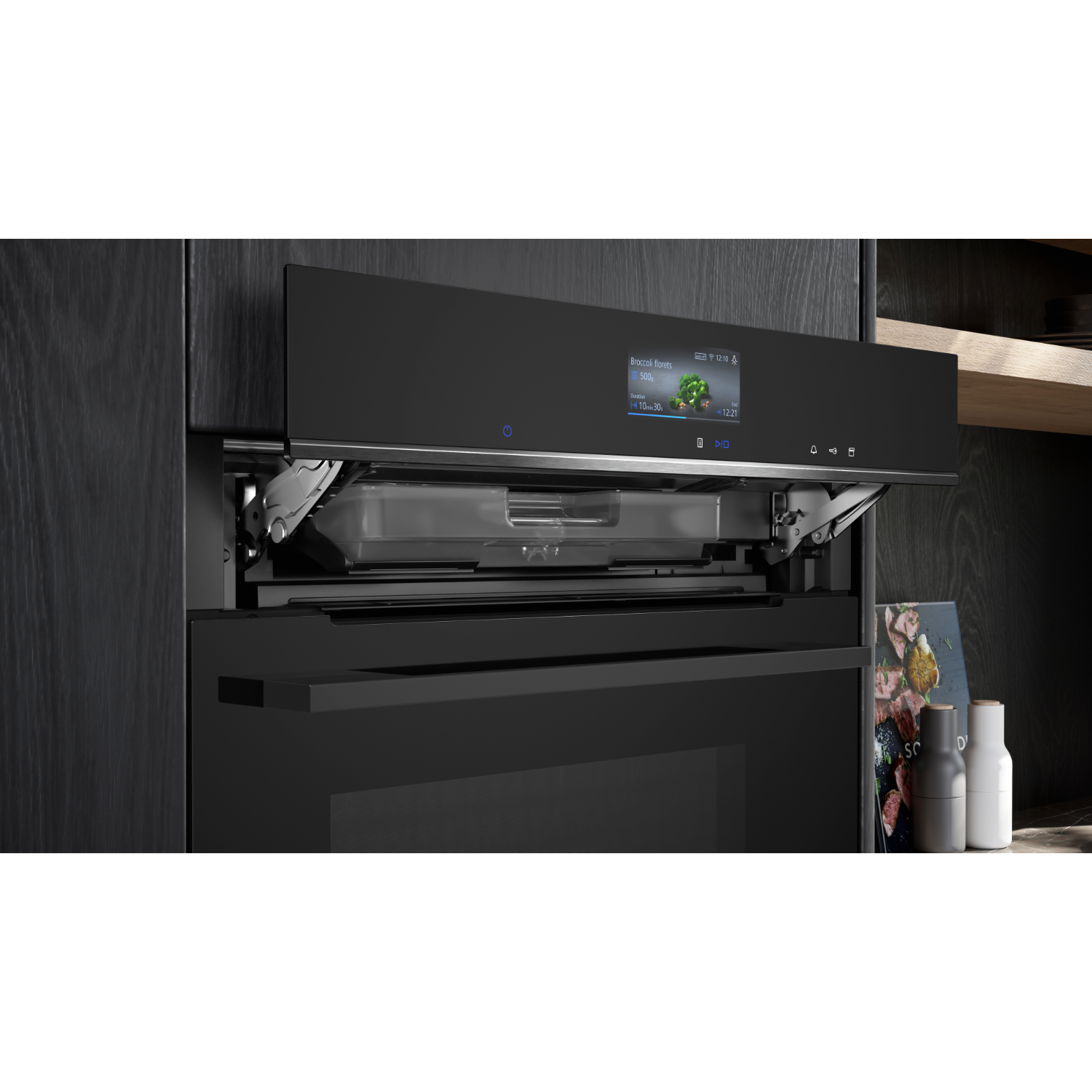 Black built-in oven with an open door, showing a screen and a tray inside. Dark wood background.