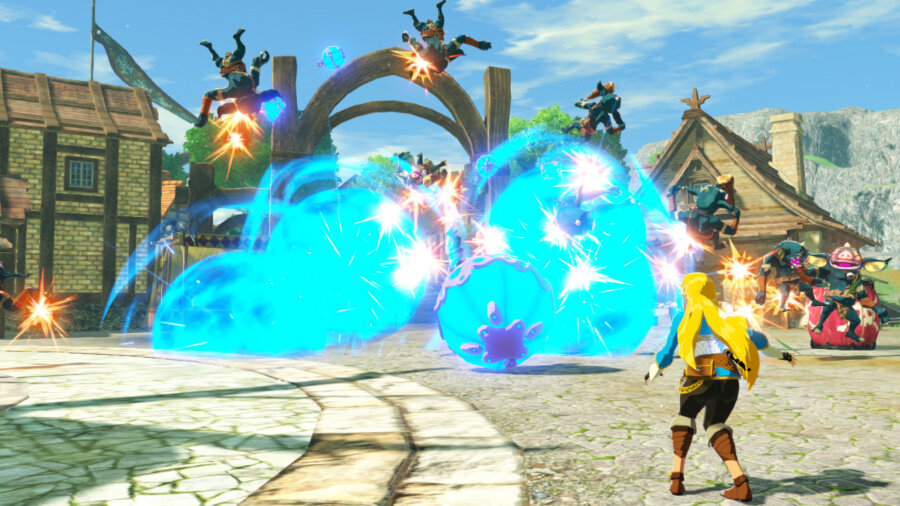 Zelda z niebieskimi wybuchami energii walczy z wrogami na placu. Budynki i niebo w tle.