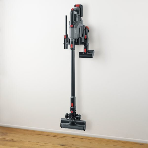 Czarno-czerwony odkurzacz bezprzewodowy zamontowany na ścianie.