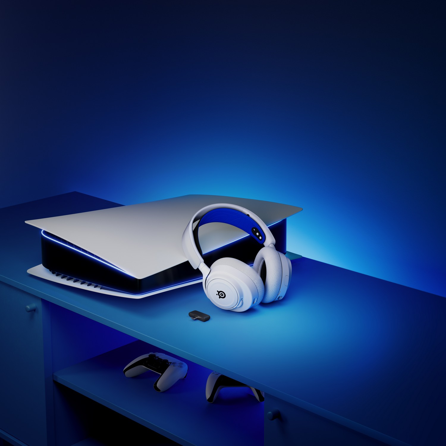 A gaming setup with a PlayStation 5, controller, and headset on a blue table.