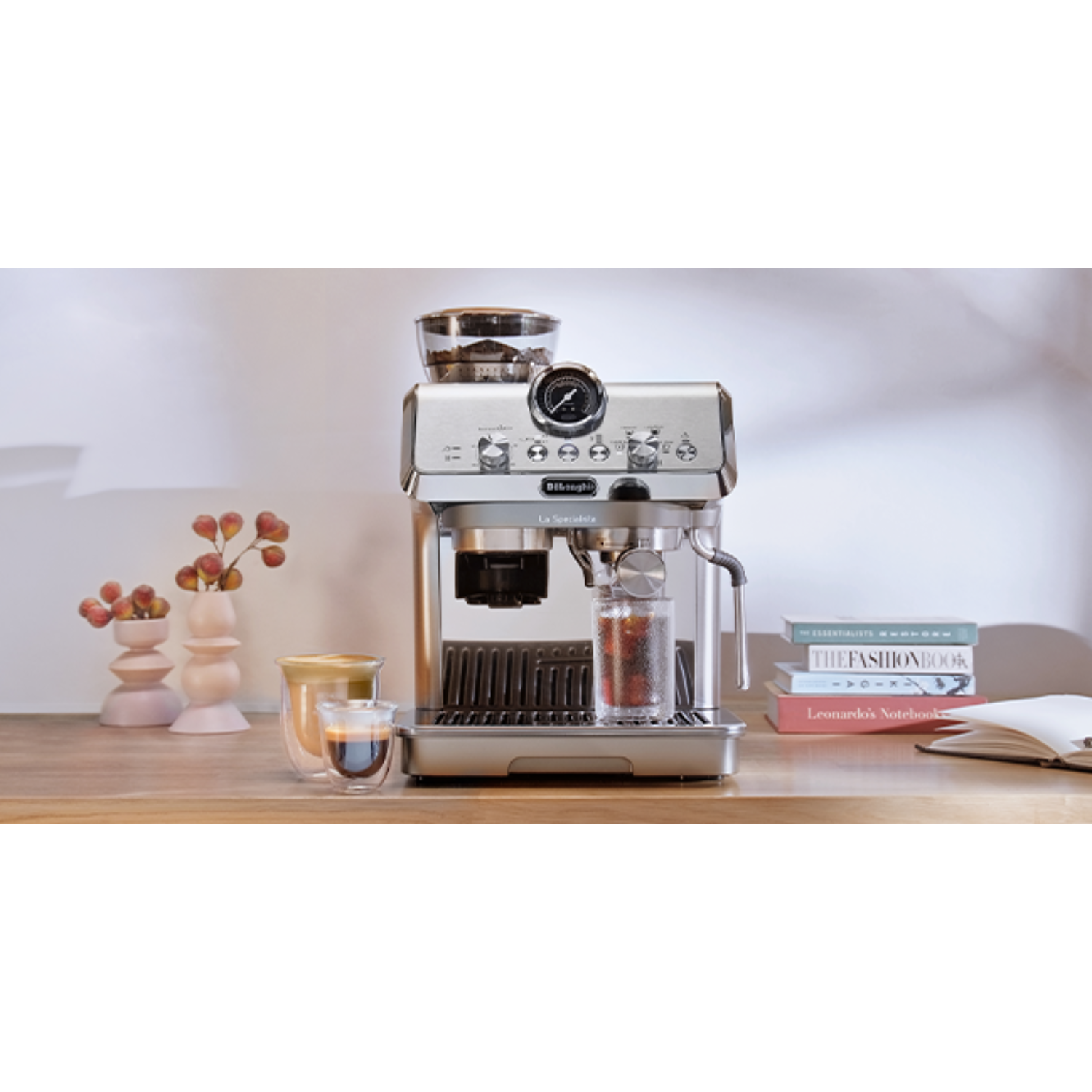 A DeLonghi La Specialista espresso machine with accessories on a wooden surface.