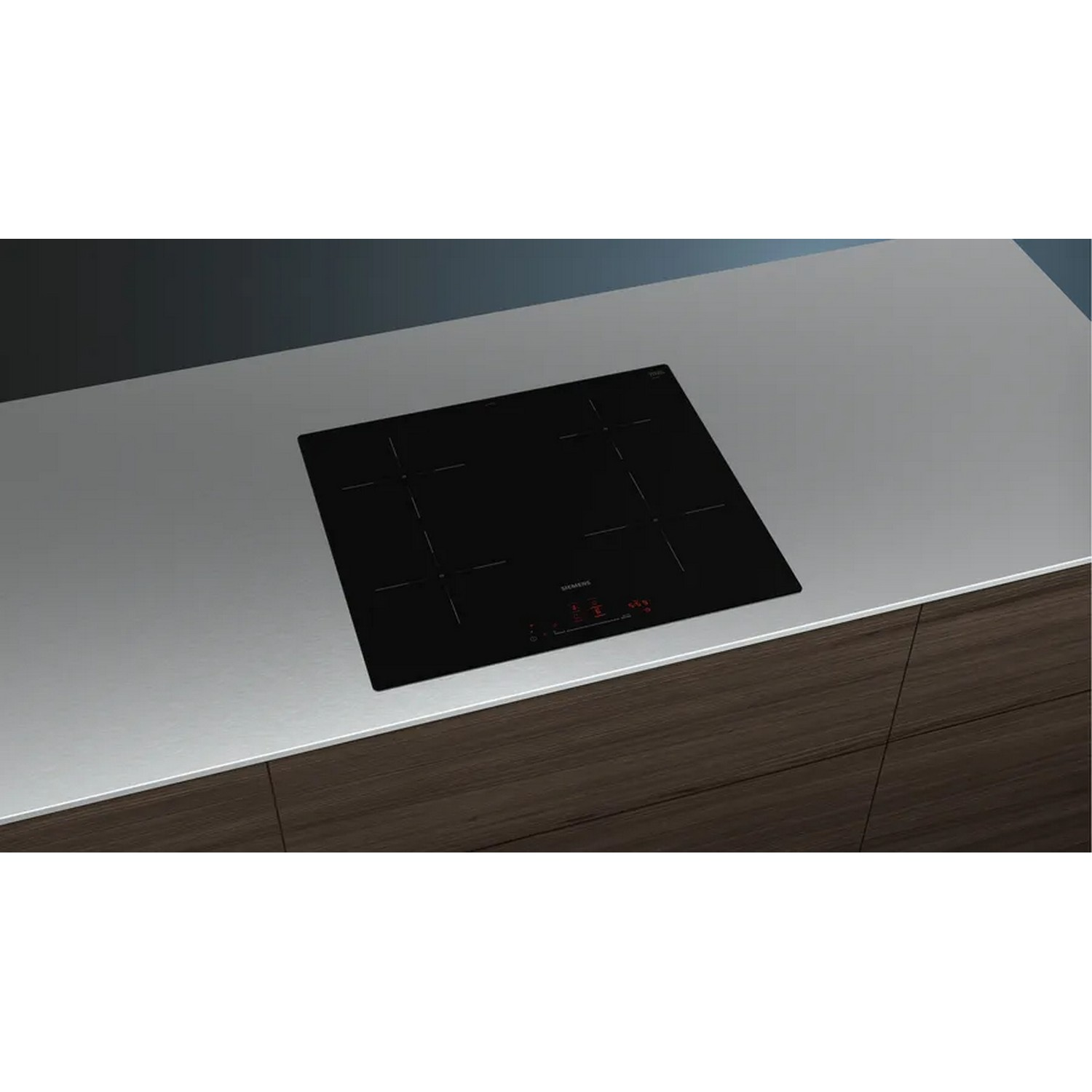 Black induction cooktop with five cooking zones on a light gray countertop.
