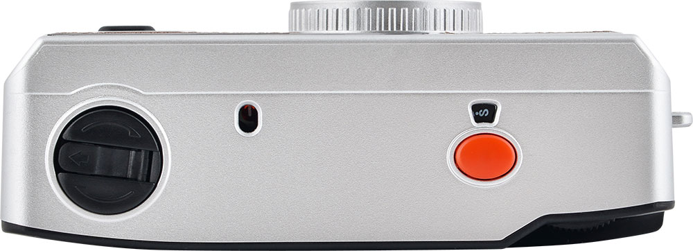 Silver camera, top view. Has a dial, a red button, and a button labeled 'S'. White background.
