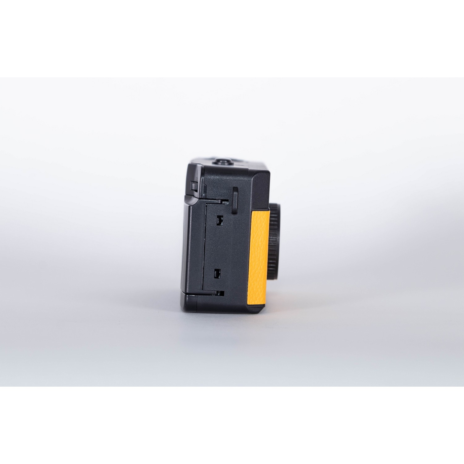 A small, black, and yellow camera. The side shows the black body and yellow accent.