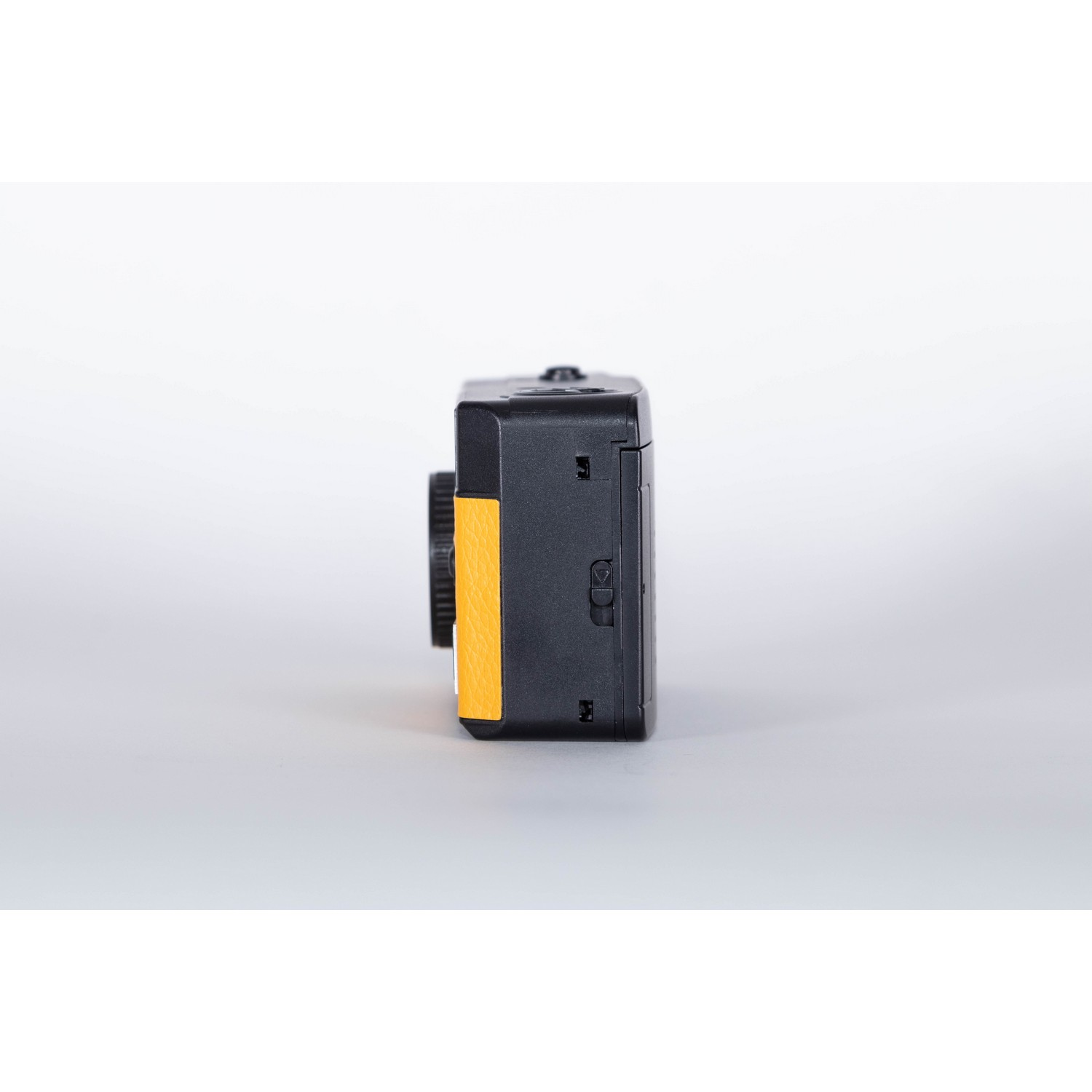 A small black and yellow camera, with a dial.