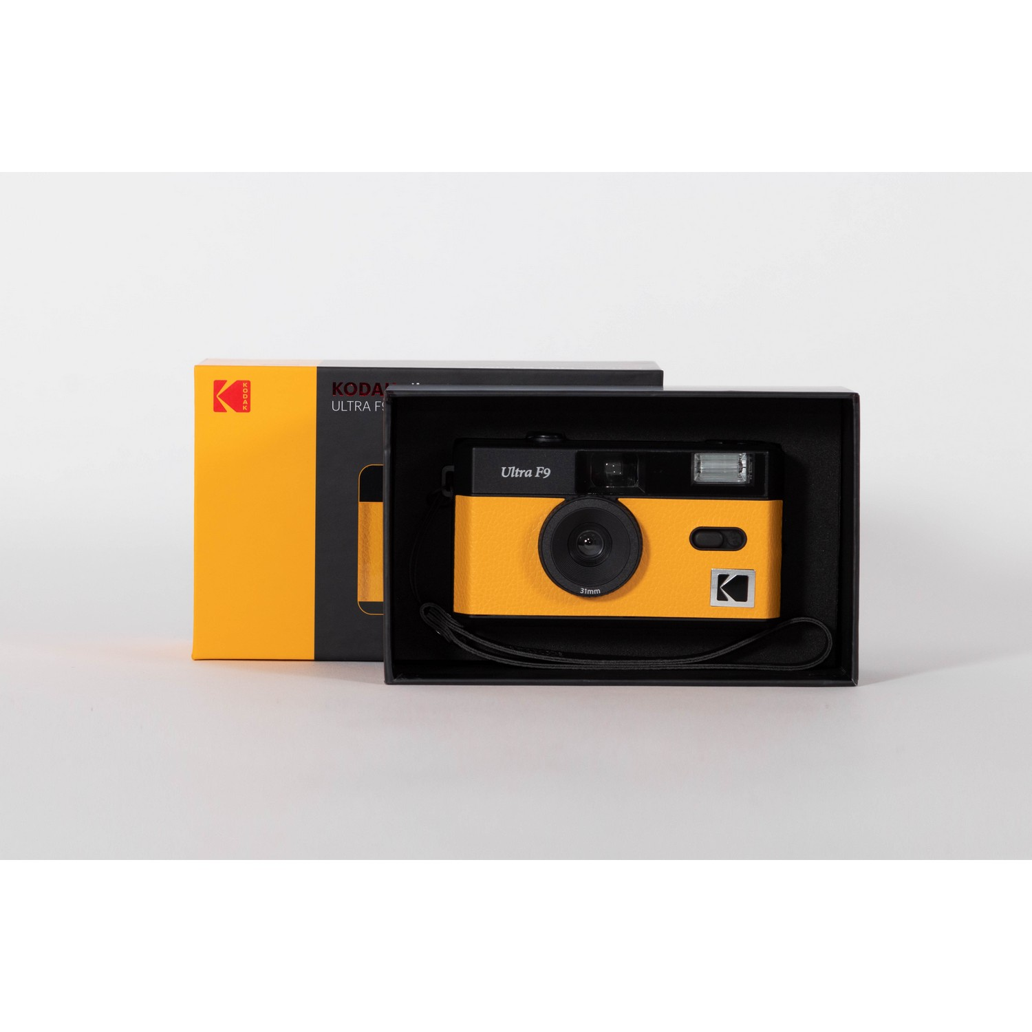 A yellow Kodak Ultra F9 camera in its black box.