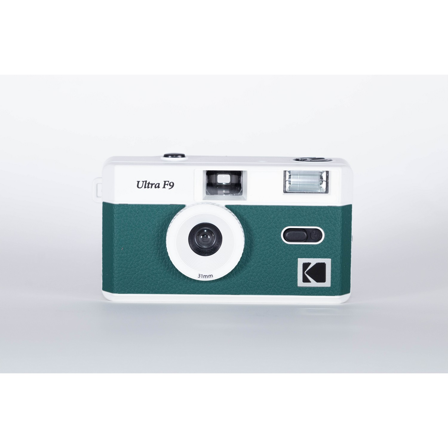 A green and white Kodak Ultra F9 camera on a white surface.