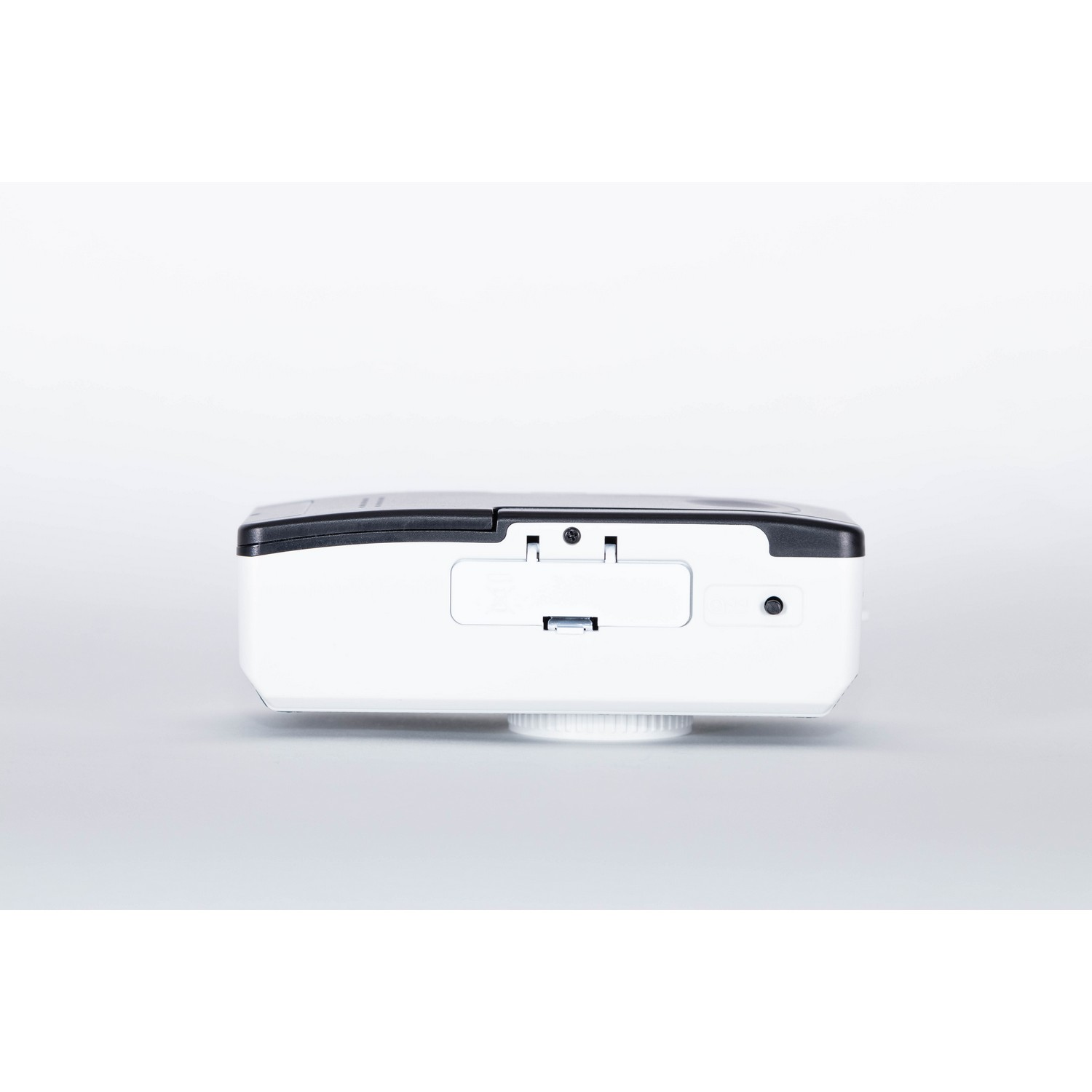 White, black-top device. Has a small screen, a button and a round base. Likely a printer or device.