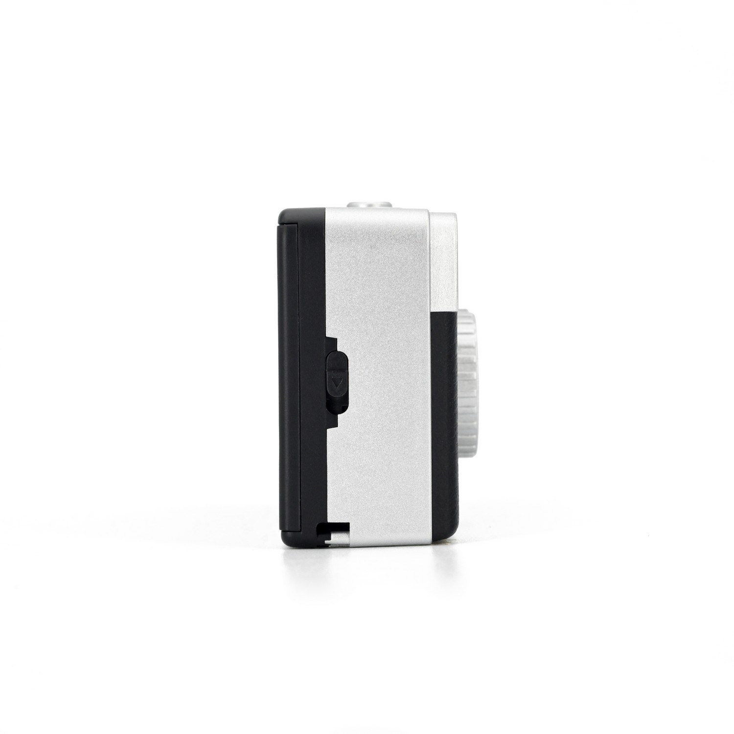 Side view of a small, silver and black camera on a white background.