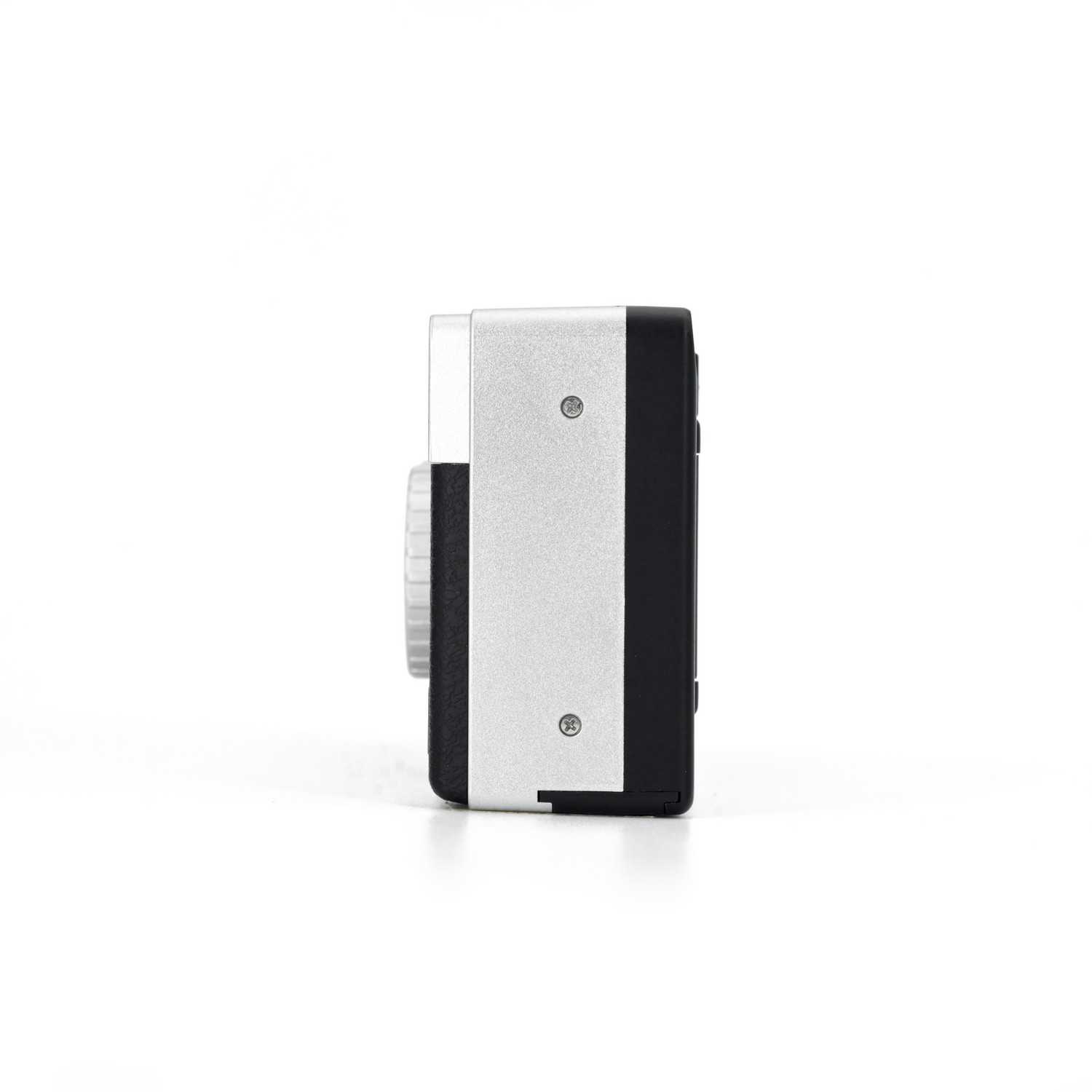 Silver and black device, side view, with a dial and two screws on a white backdrop.